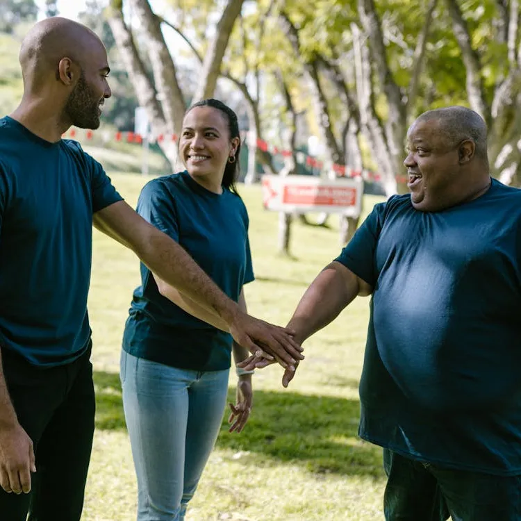 Three people working together and smiling